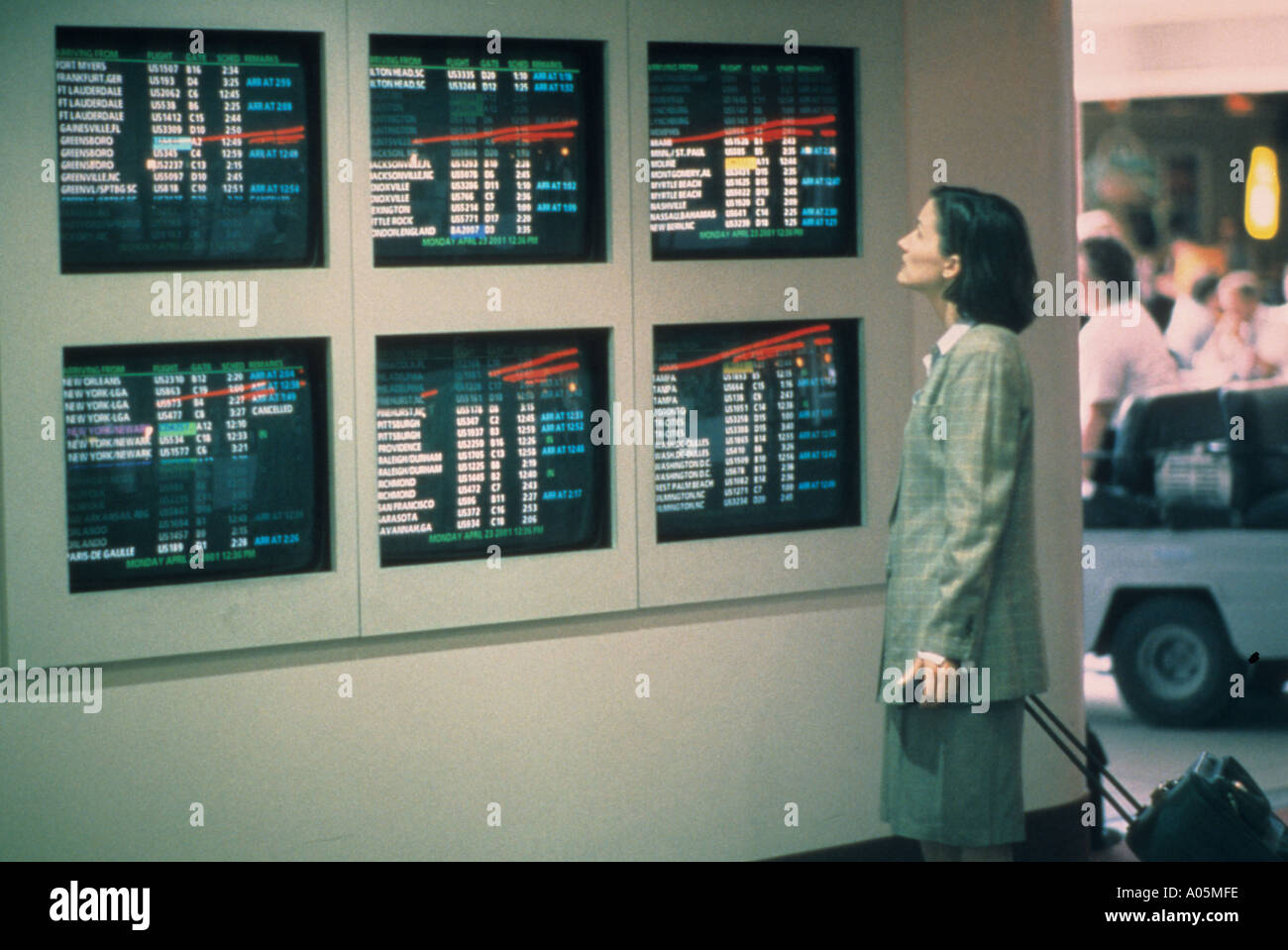 Businesswoman checks the airline schedule as she prepares to travel Stock Photo