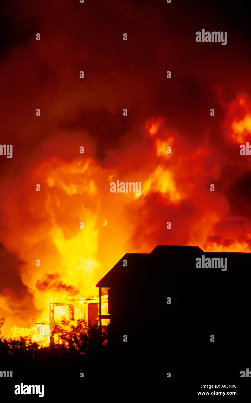 Orange flames against the night sky as a new condominium development burns out of control near Tampa Florida USA Stock Photo