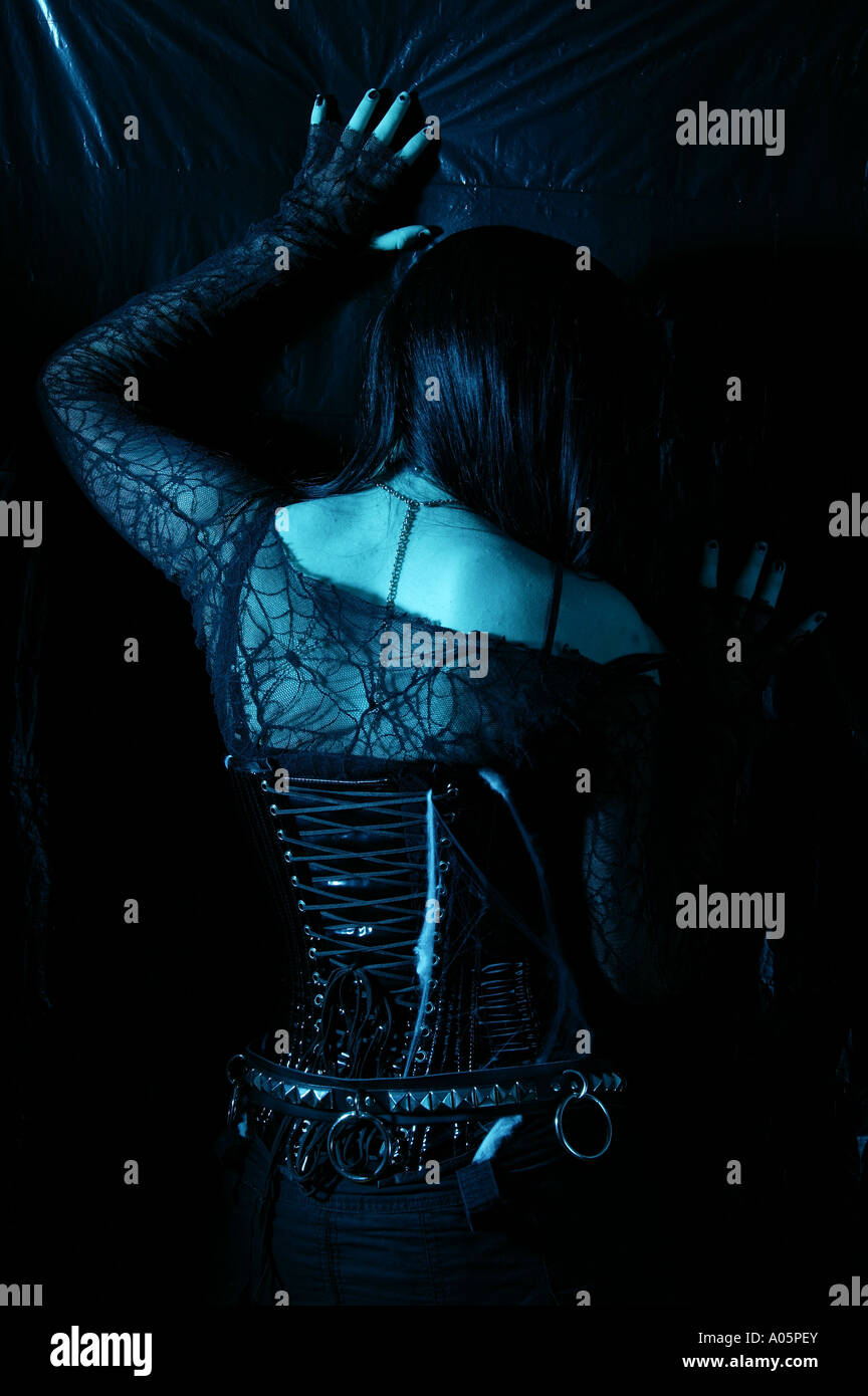 Gothic woman posing alternative fashion clothing against a dark background  and dramatic lighting Stock Photo - Alamy