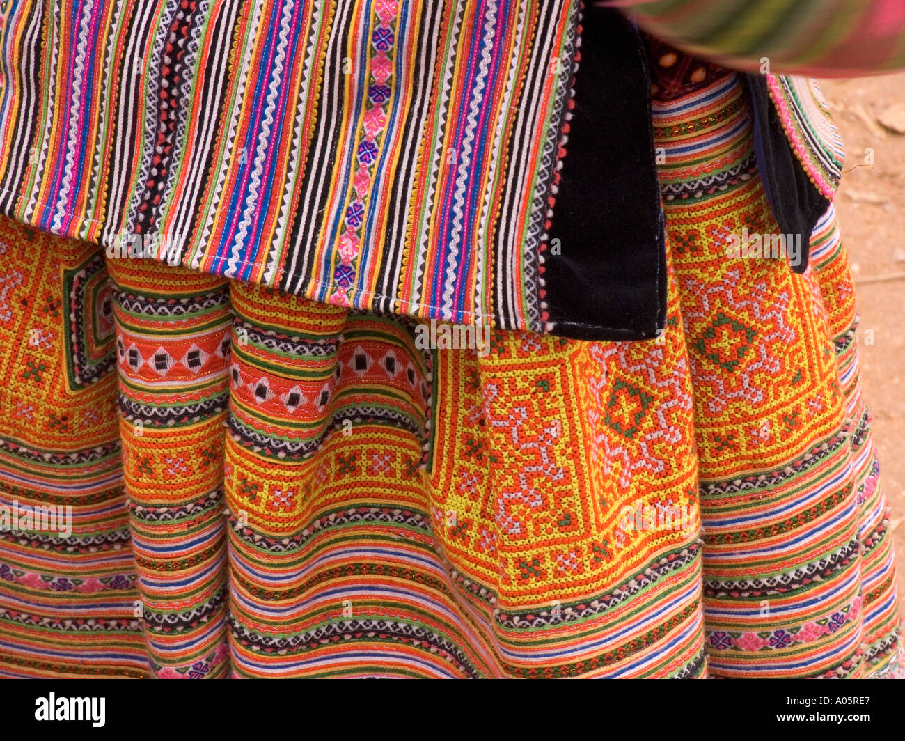 Northeast Vietnam Can Cau Flower H mong minority hilltribe market detail of woven and embroidered womans jacket and skirt Stock Photo