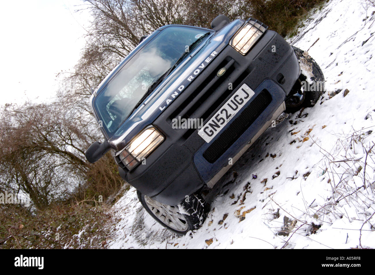 Land Rover Freelander in snow covered forest clearing Kent England Stock Photo