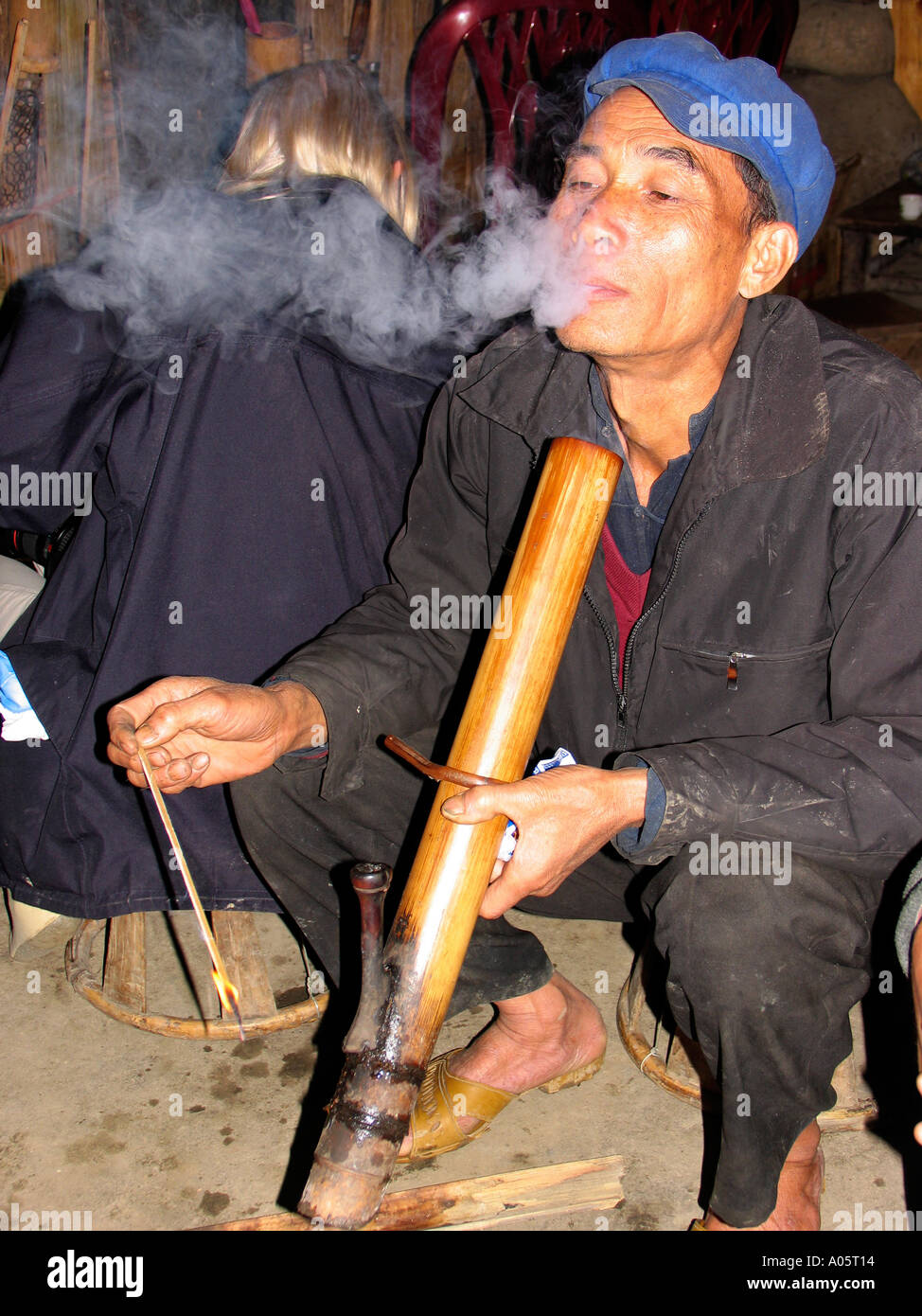 northwest Vietnam Sapa Hill tribal area Ban Ho Village People Tay man smoking bamboo pipe in village house Stock Photo