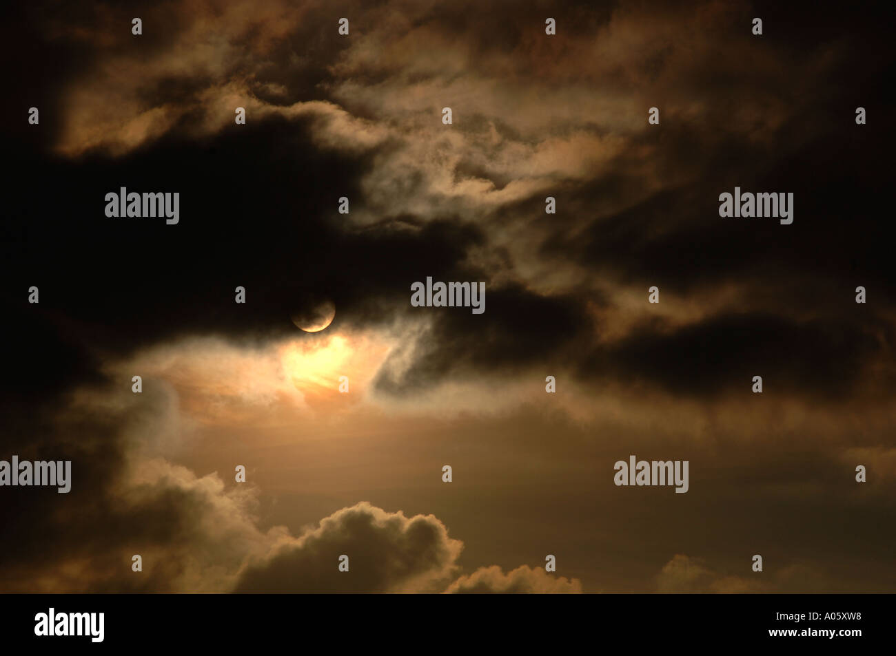 The Sun Appearing From Behind Clouds Stock Photo