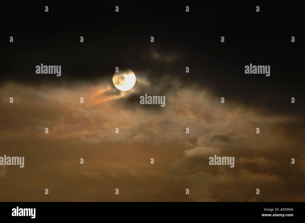 The Sun Appearing From Behind Clouds Stock Photo