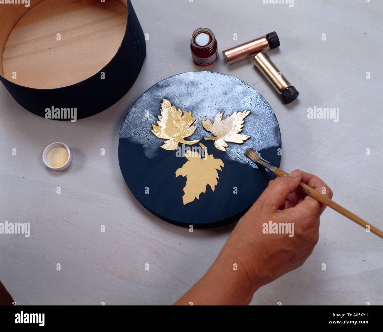 Closeup of hands applying lacquer to decoupage box Stock Photo Alamy