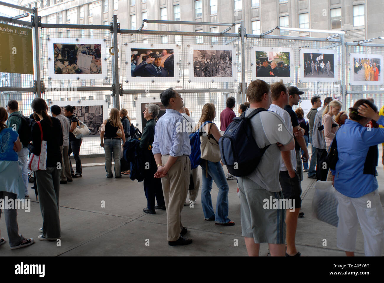 Visitors to Ground Zero looking at photos about the nine eleven attack