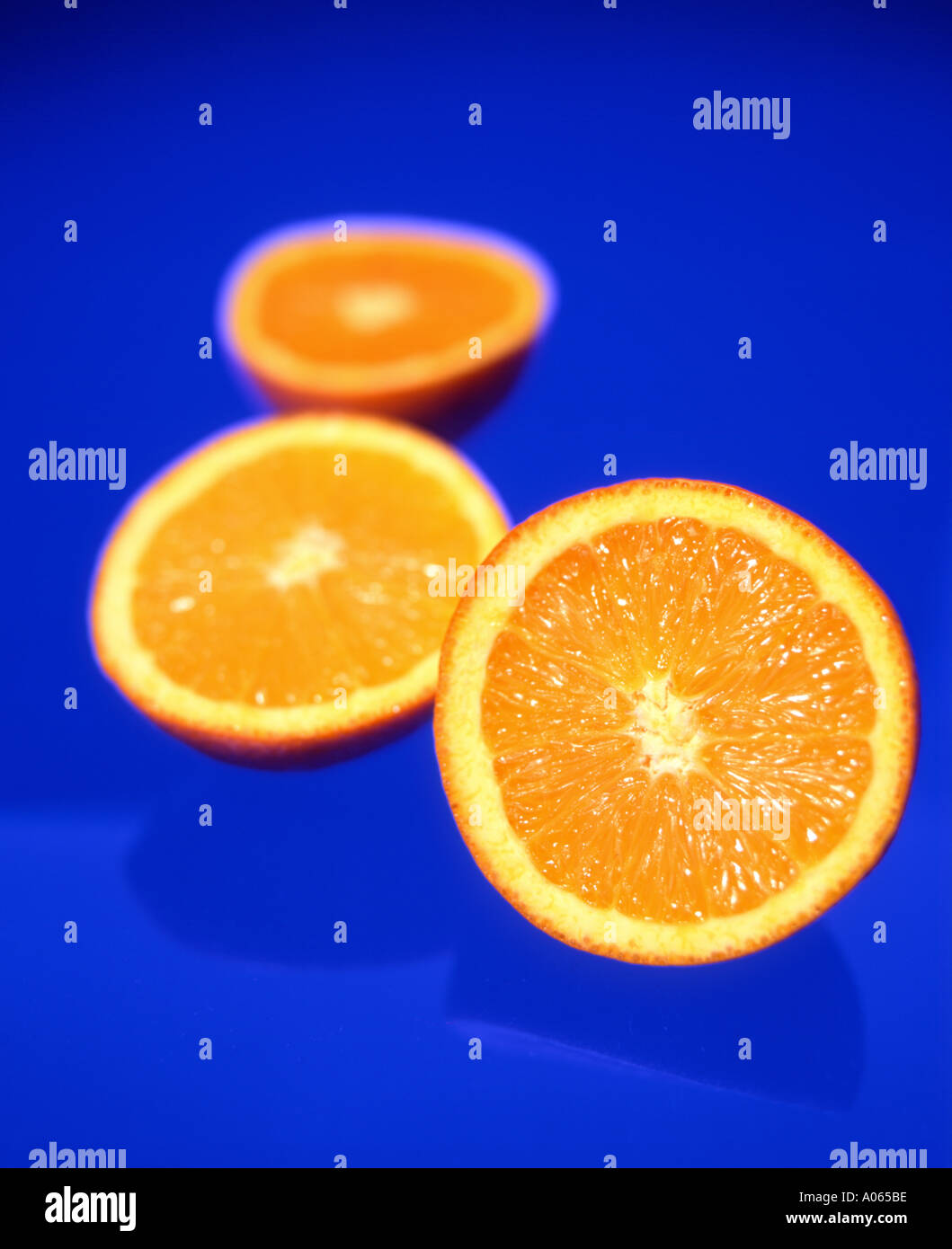 Orange halves on Blue Background Stock Photo Alamy