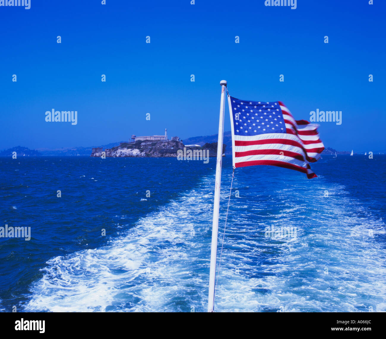 Stars and Stripes flag with Alcatraz island an abandoned prison in the background. Stock Photo