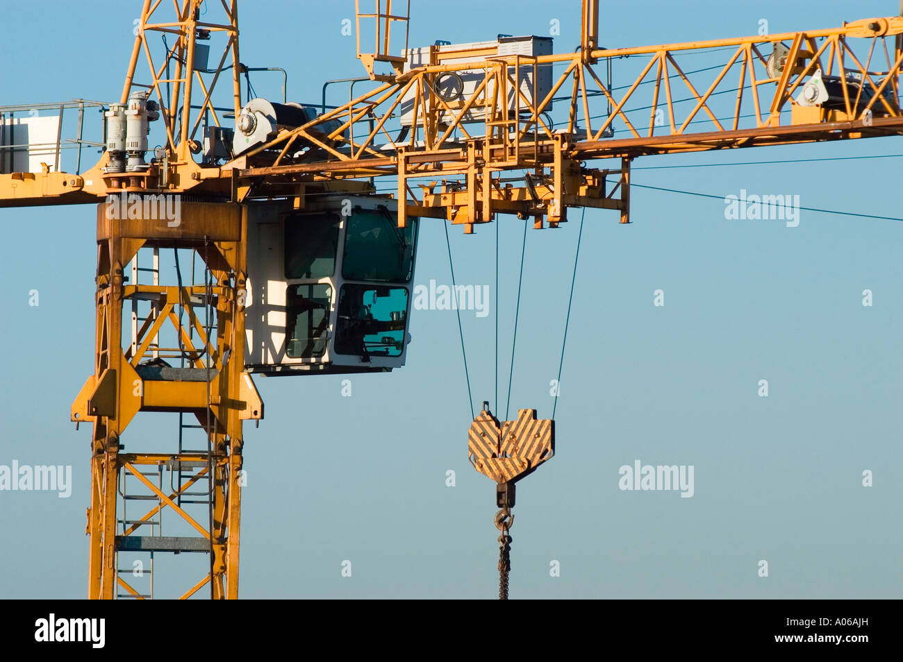 Close up of part of construction crane with operator cabin and blue sky in background Stock Photo