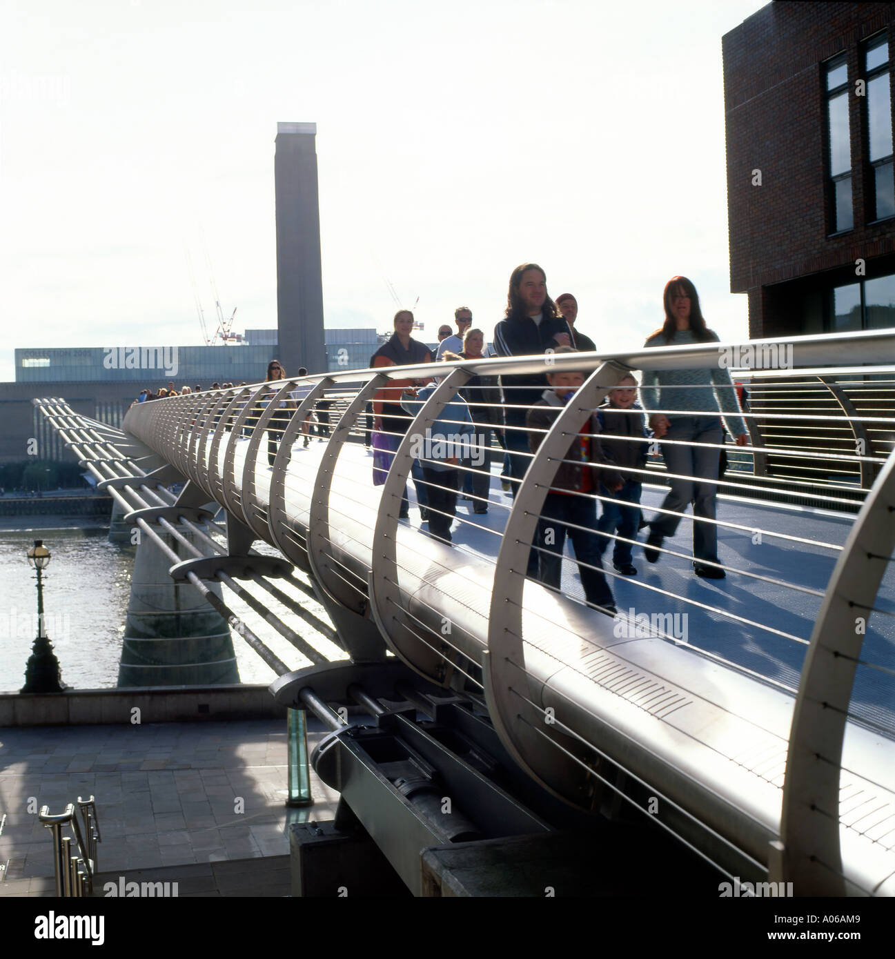 People crossing the Millennium Bridge with the Tate Modern in the distance in London England UK KATHY DEWITT Stock Photo