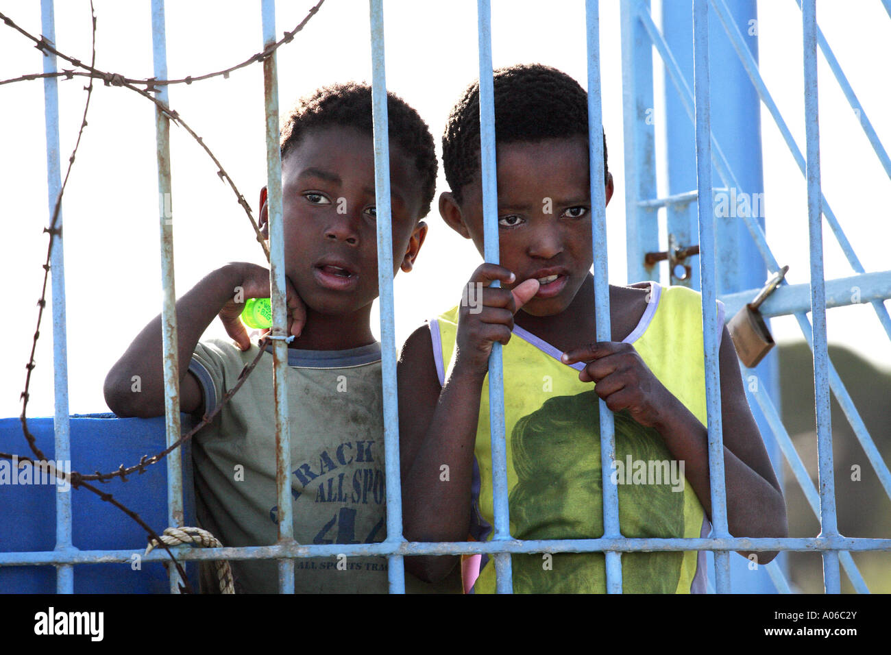 two young african boys behind gate in South Africa Stock Photo