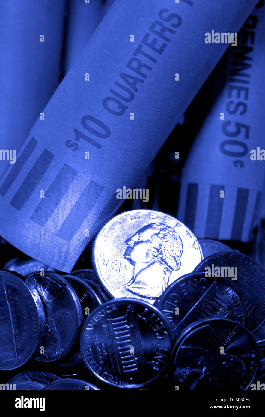 Close up of quarter in jar with other coins and coin wrappers Toned
