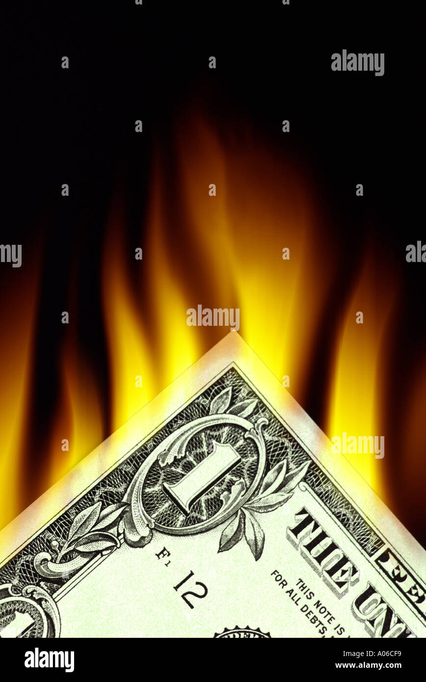 United States currency on fire Corner of one dollar bill Stock Photo