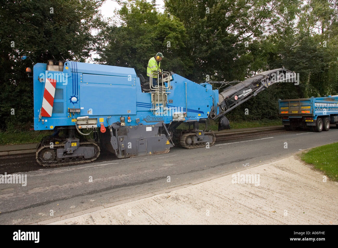 asphalt being planed (removed) before resurfacing a road Stock Photo