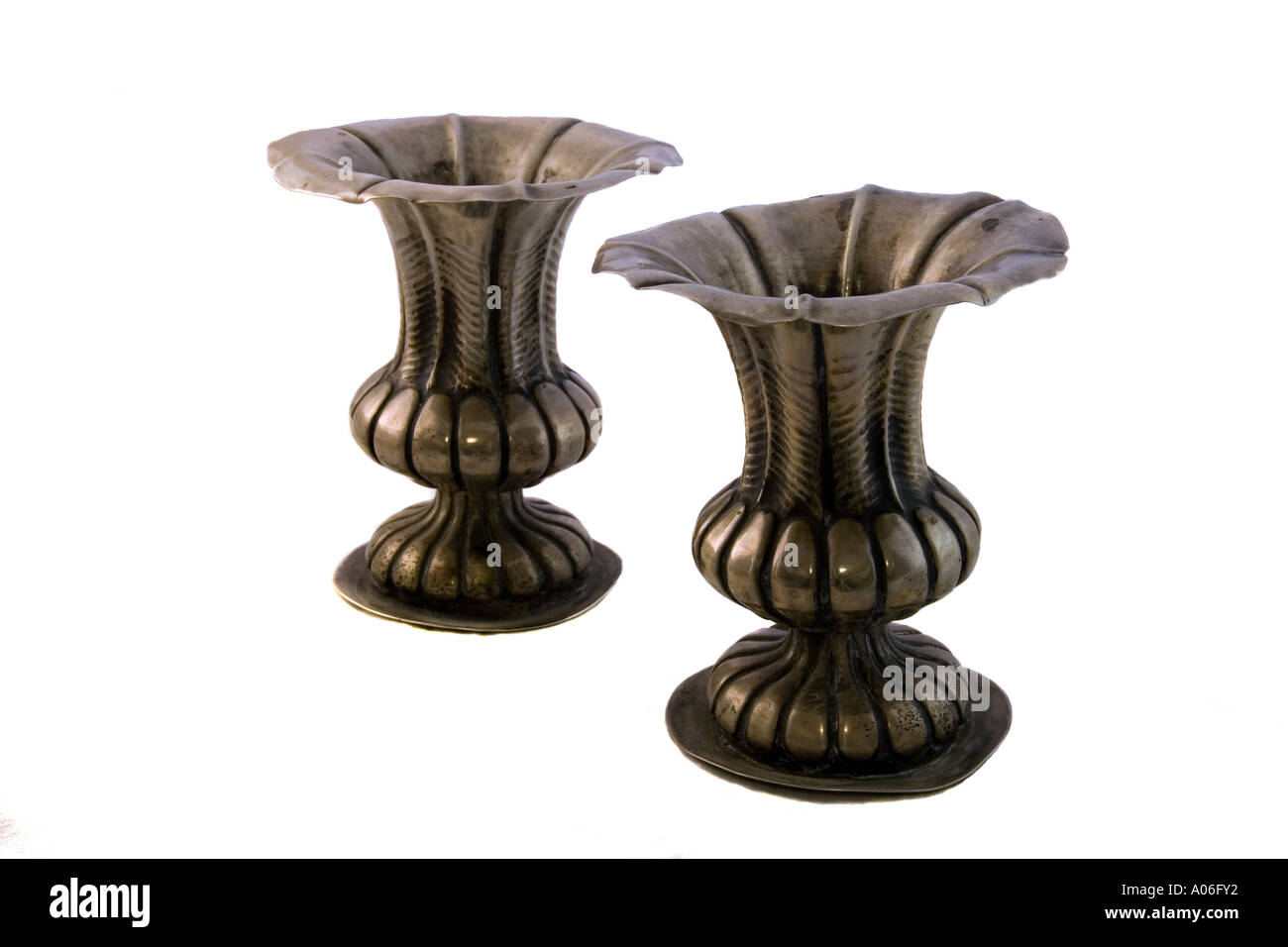 Two antique silver candlesticks isolated on white background Stock