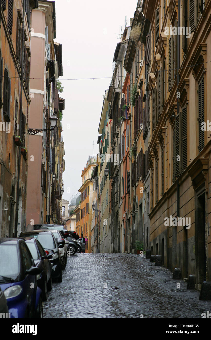 Typical cobbled road Roman townhouses and restaurants in this backstreet image of Rome Italy European holiday travel destination Stock Photo