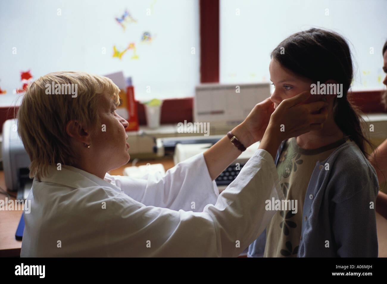Woman Doctor examines nine year old girl for skin condition prague Czech Republic Stock Photo
