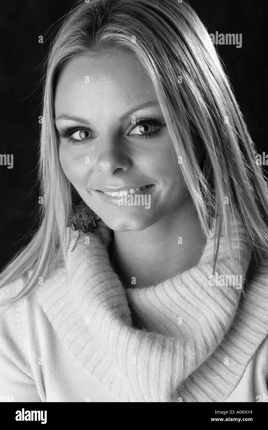 Monochrome Portrait of a Smiling Blonde Girl Wearing a Jumper Stock Photo