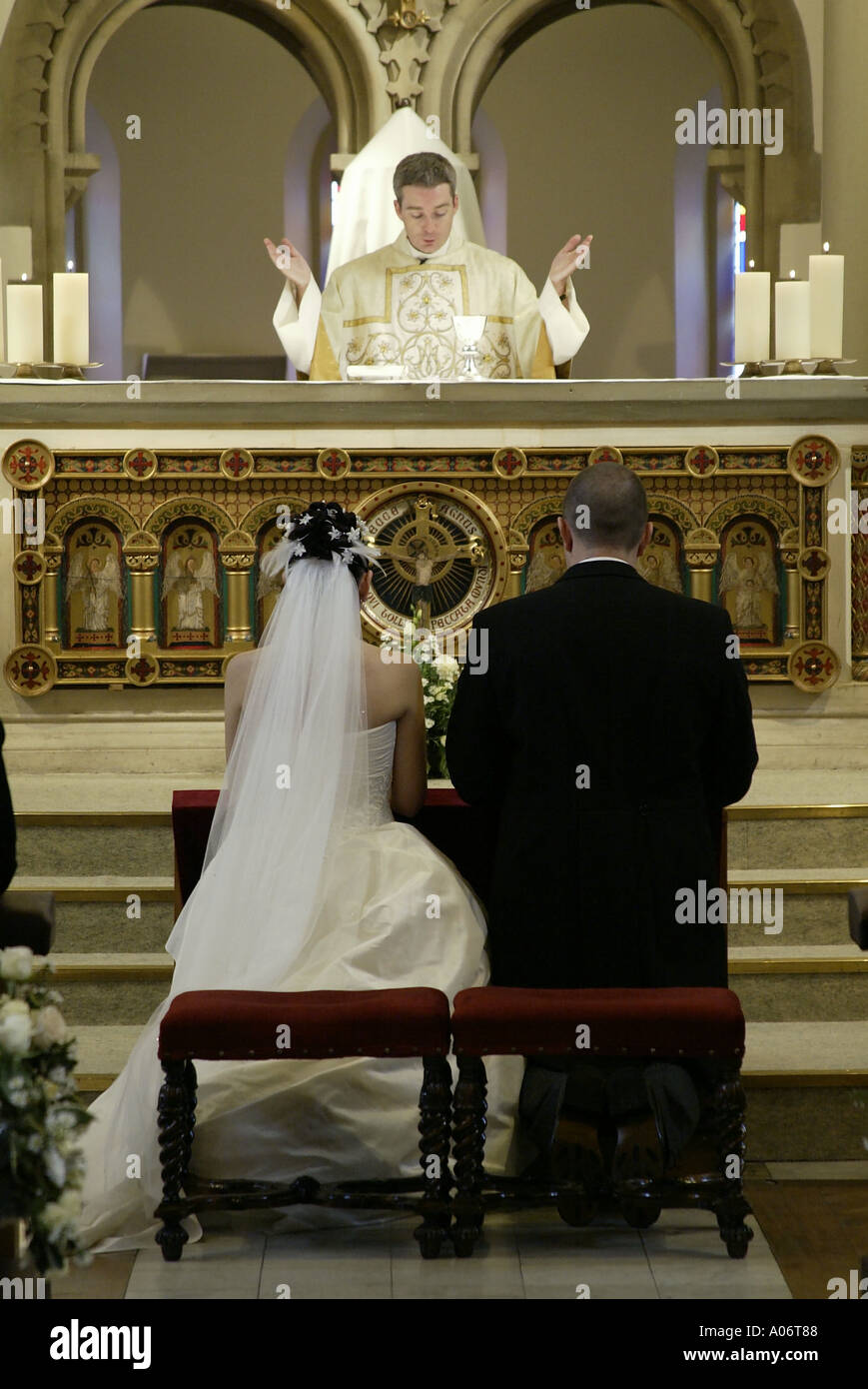 Bride and groom taking prayers during uk Catholic wedding ceremony Stock Photo