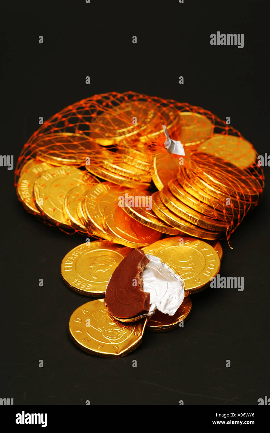 Milk chocolate gold coins in net hires stock photography and images