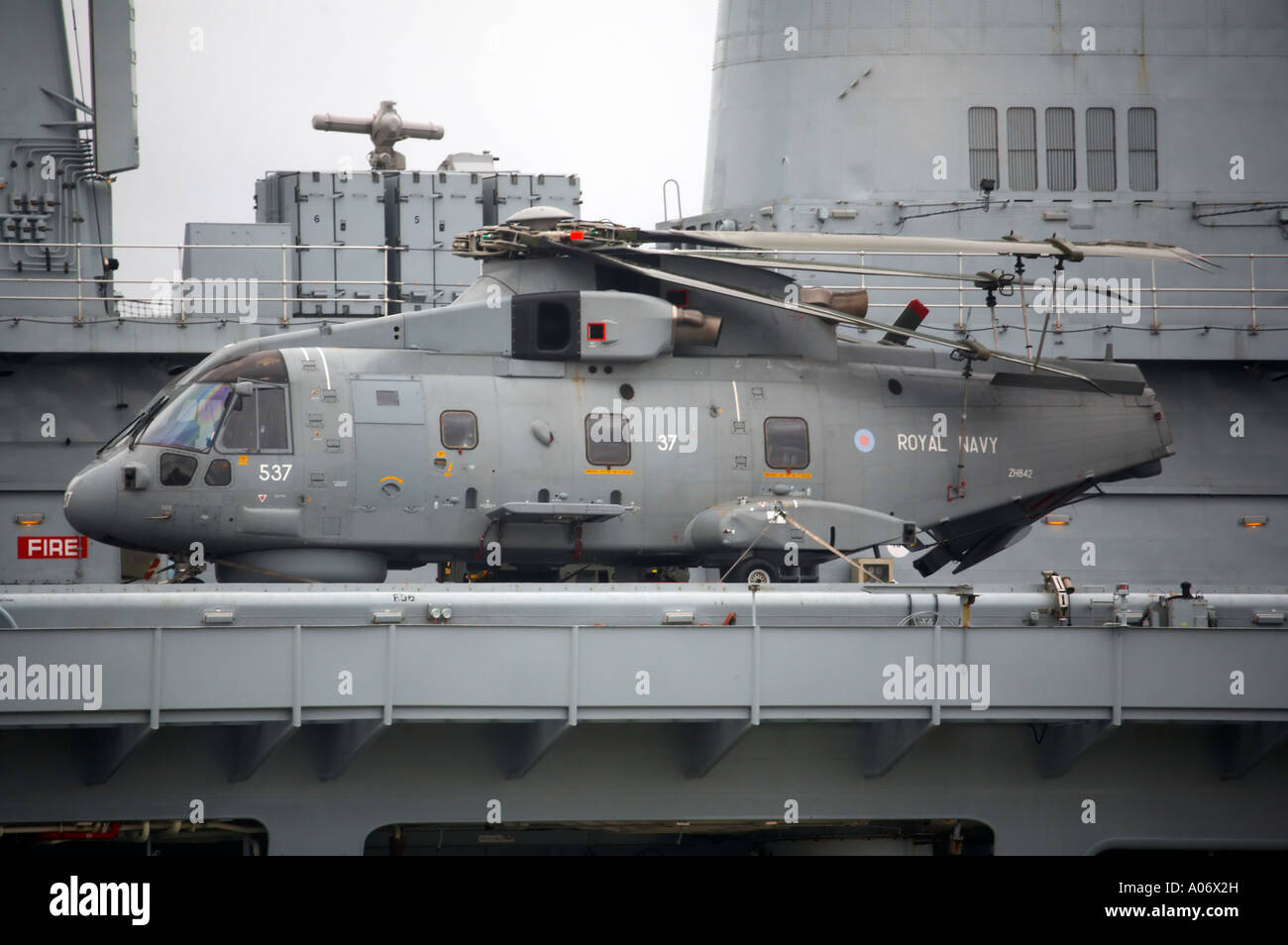 Merlin helicopter with rotors stowed and tail folded whilst on deck of HMS Illustrious Stock Photo