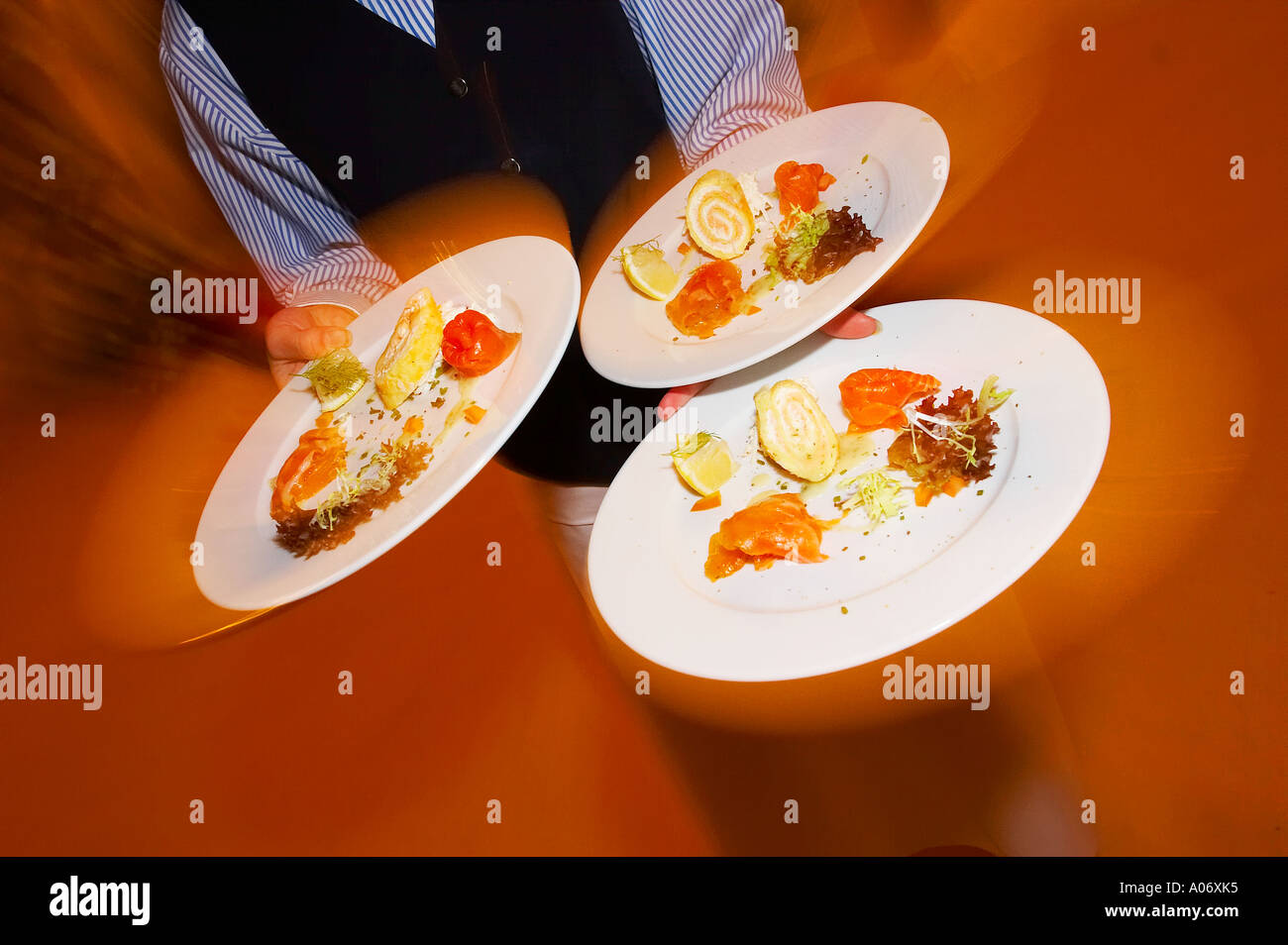 Waiter carrying three plates Stock Photo Alamy