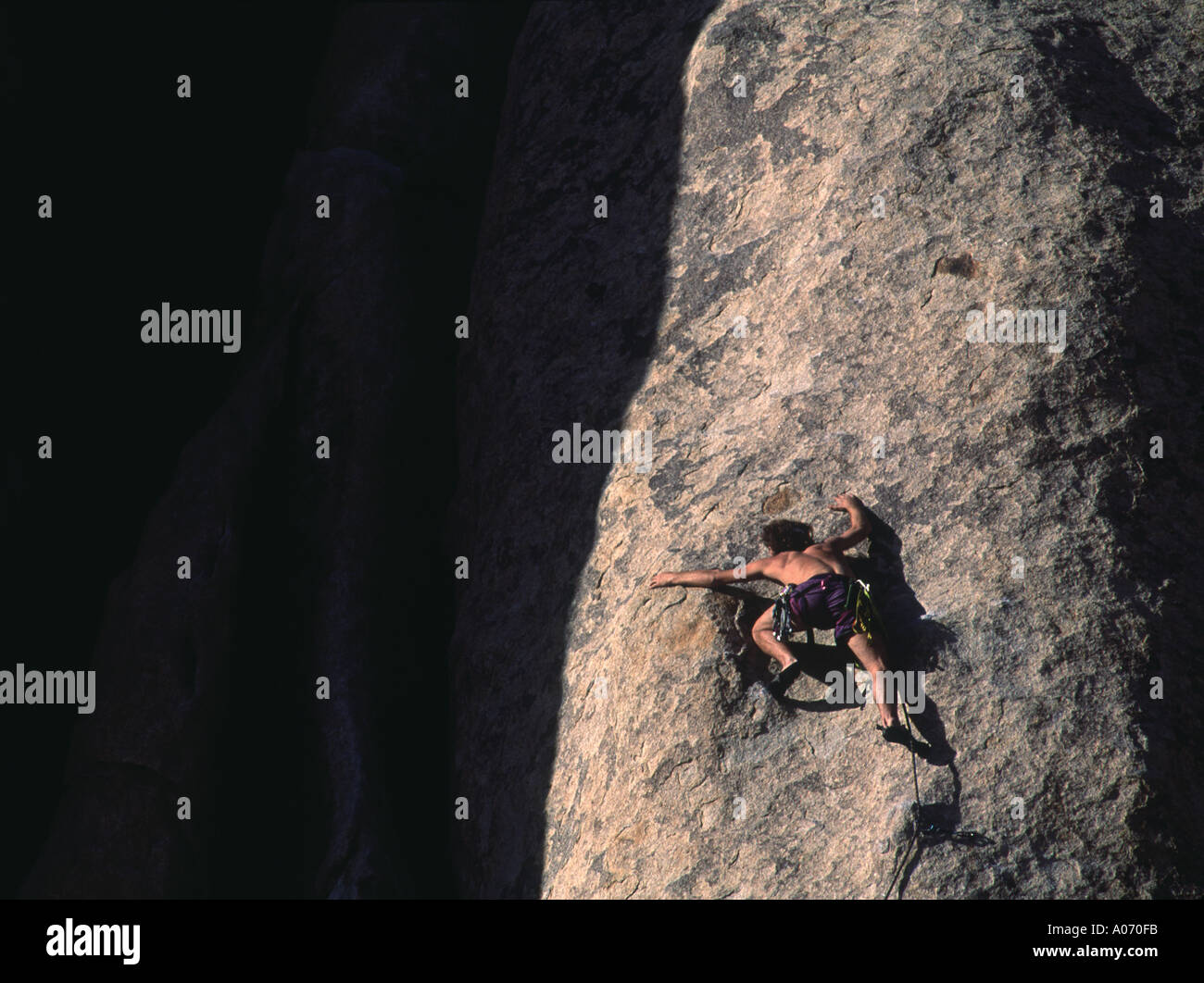 California Joshua Tree National Monument climber lead scaling mountain Stock Photo
