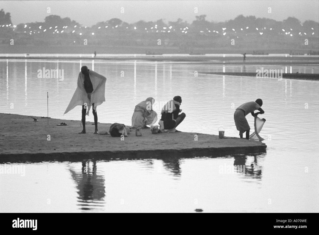 Four men bathing in Ganges river at Kumbh fair Allahabad Uttar Pradesh India Stock Photo