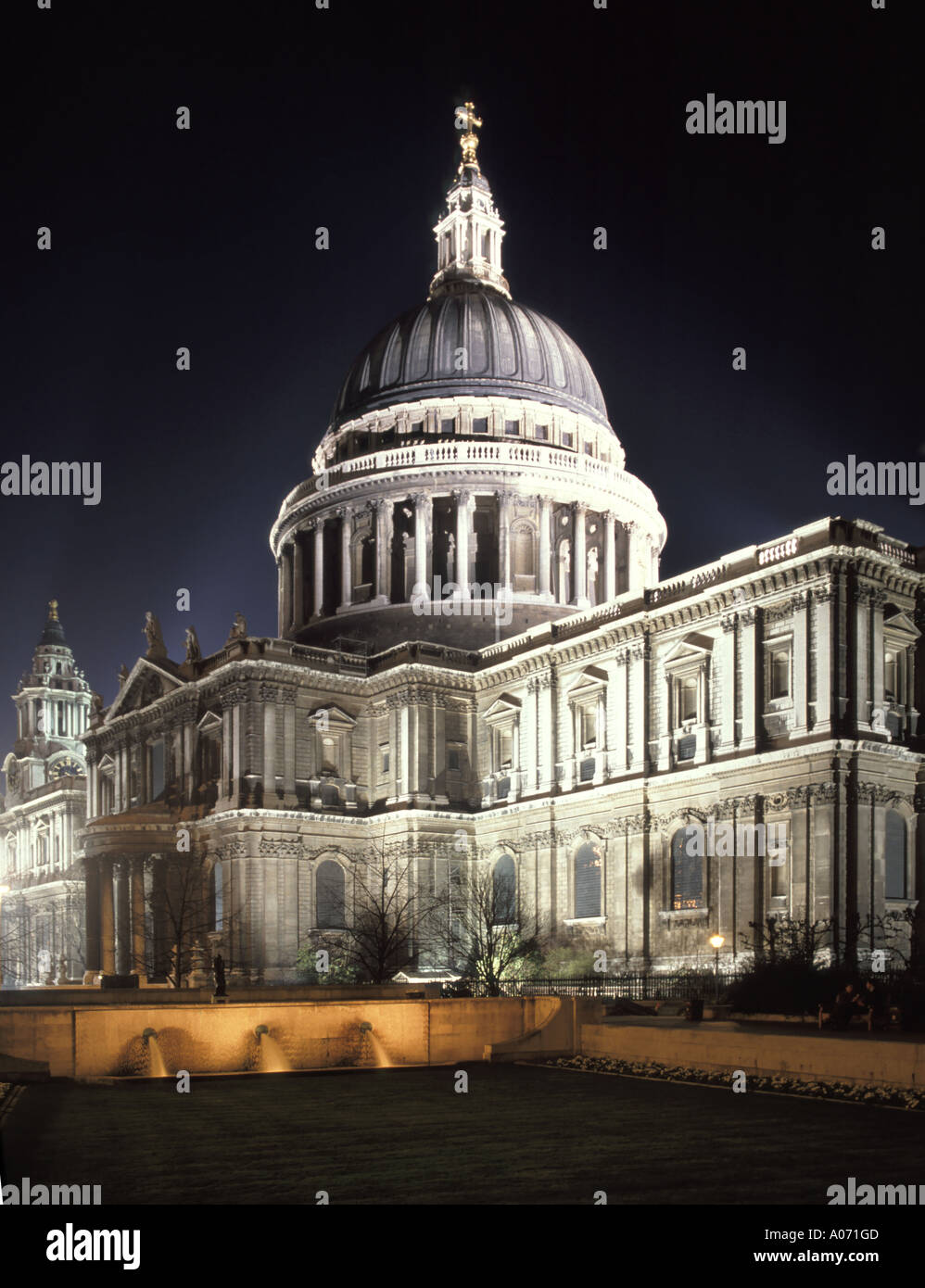 Night street scene City of London floodlit fountain & floodlights Sir Christopher Wren iconic historical dome St Pauls cathedral building England UK Stock Photo
