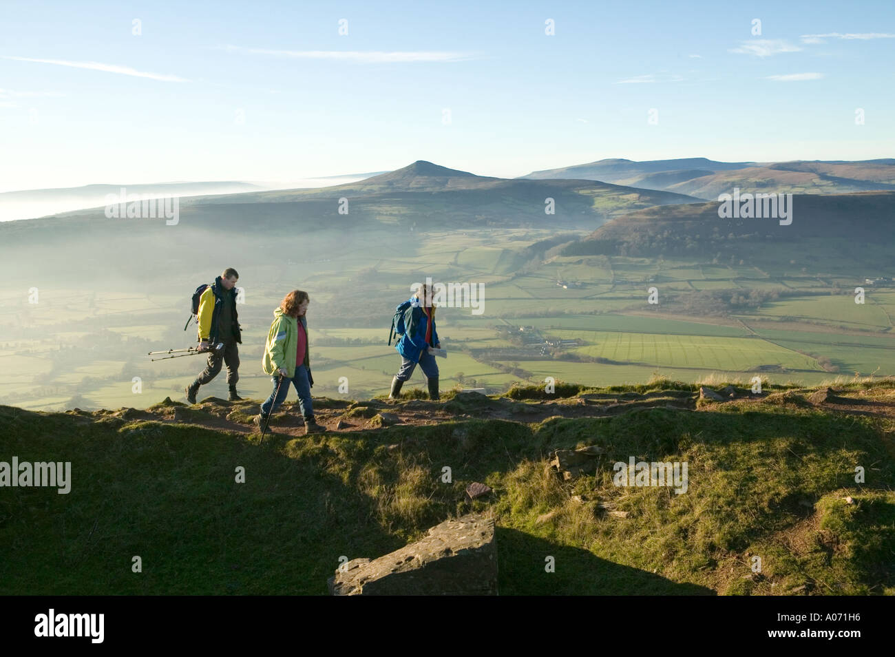 Three adult hikers walking on the Skirrid Fawr Wales UK Stock Photo