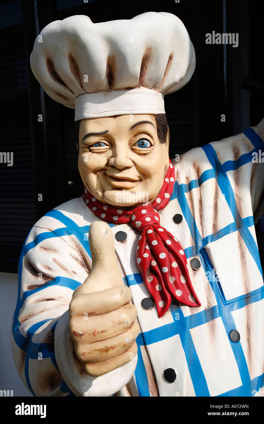 Giant model male chef with traditional chefs hat and clothing winking