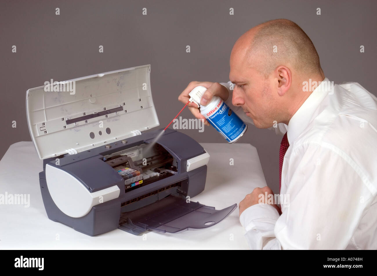 Man Cleaning Computer Printer With Compressed Air Stock Photo Alamy