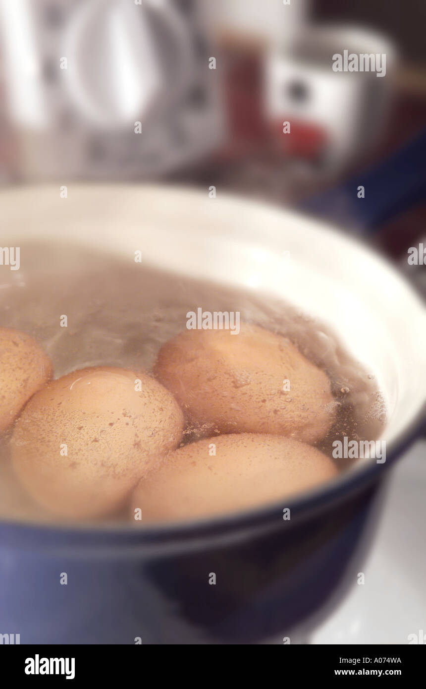 boiling eggs in saucepan Stock Photo