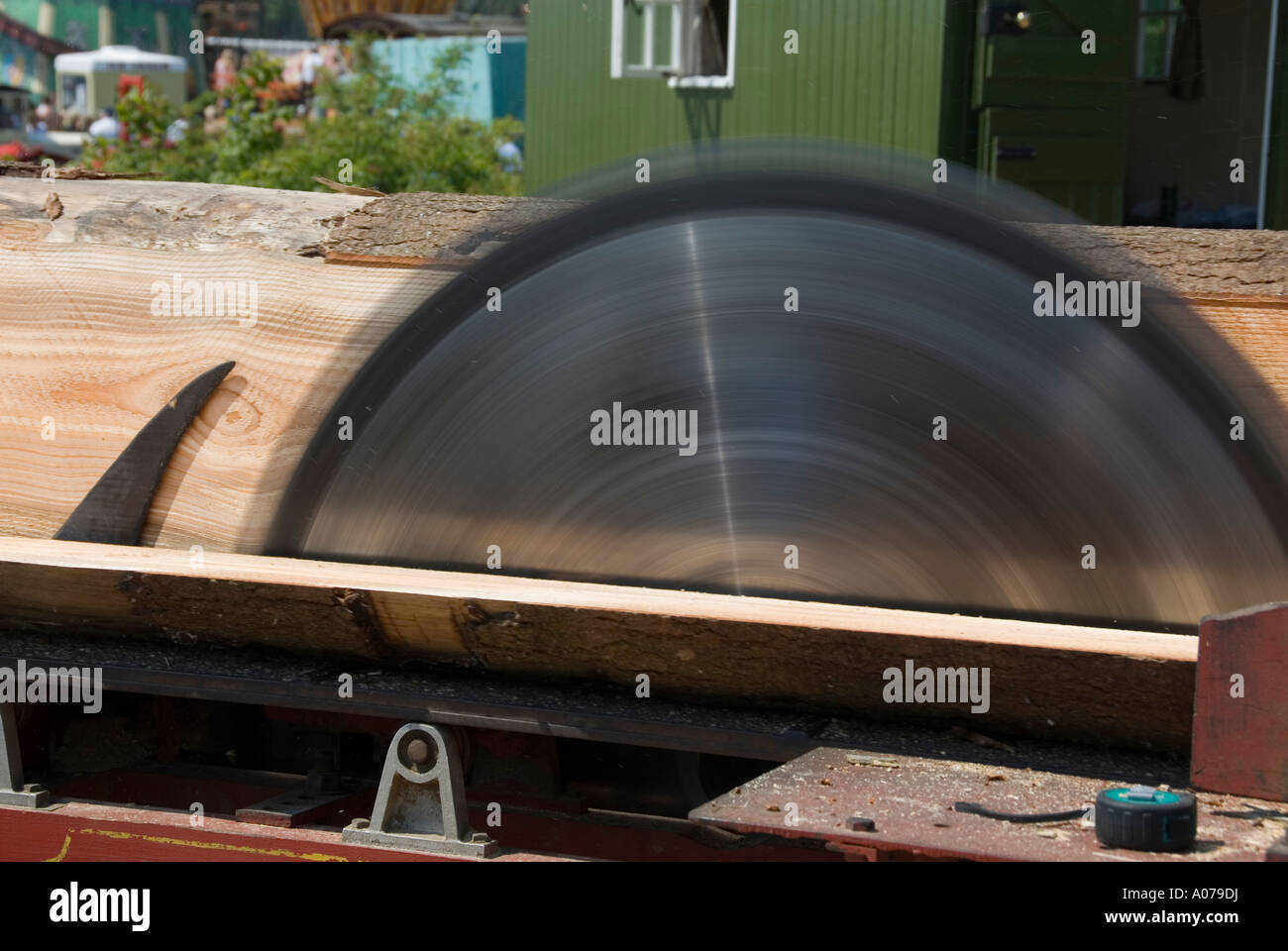 Circular Saw Blade Sawing Through A Long Tree Log Using A Fixed