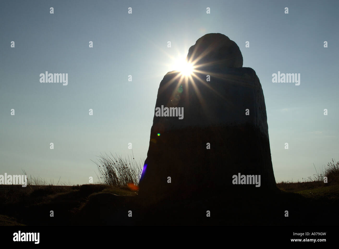 Fat Betty also known as White Cross an ancient stone monument on windswept Danby High Moor backlit silhouette Stock Photo