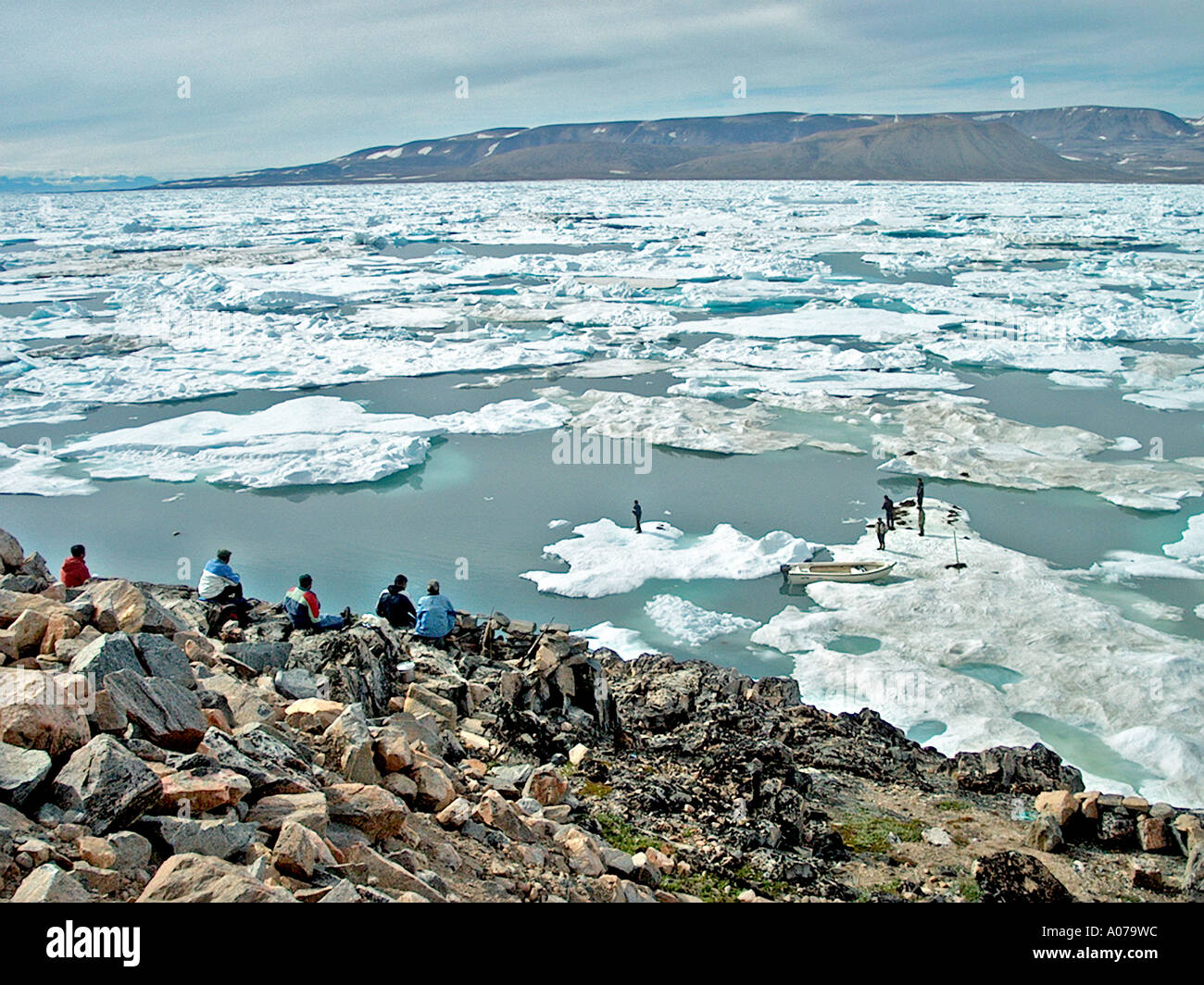 Sea Hunters on the Rocks Greenland Stock Photo