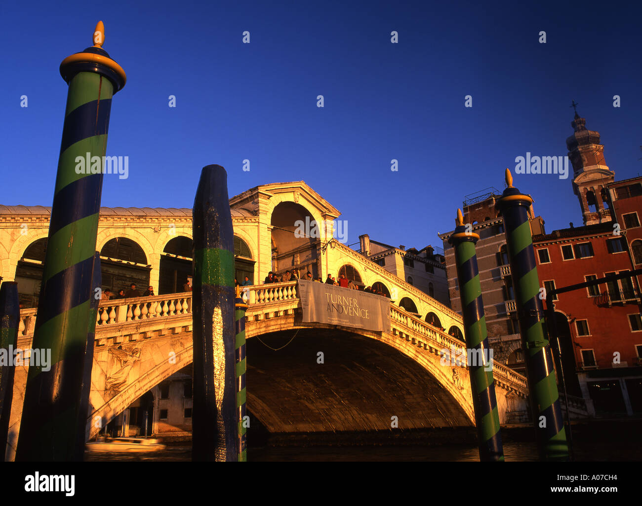 Rialto bridge Moorings in foreground People on bridge Venice Veneto Italy Stock Photo