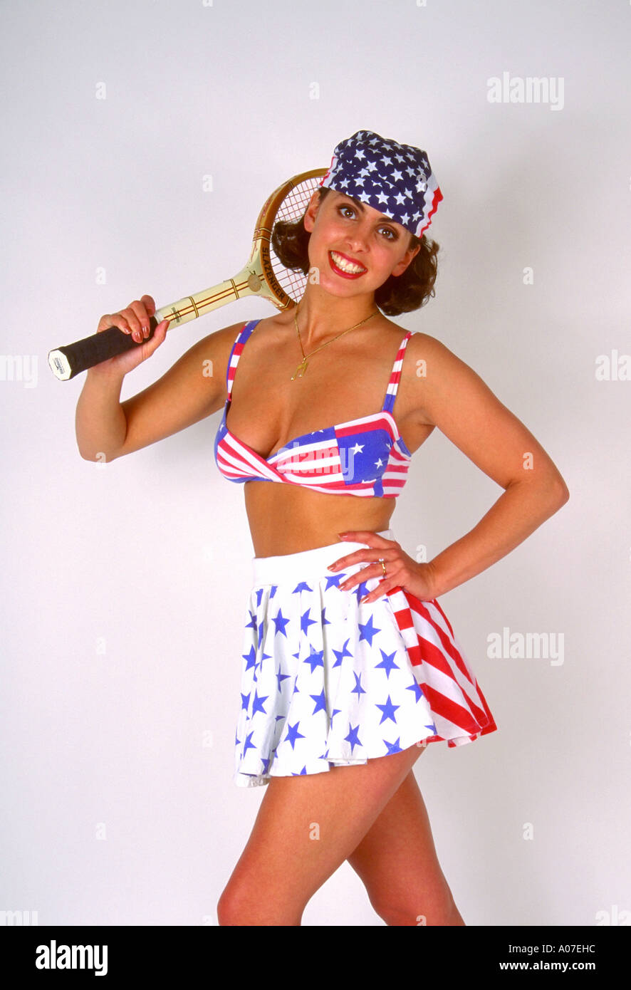 Portrait of a Young Woman in a Tennis Outfit Holding a Tennis Racket Stock Photo