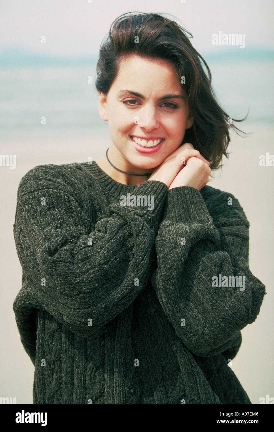 Girl in a Green Jumper on a Beach Stock Photo