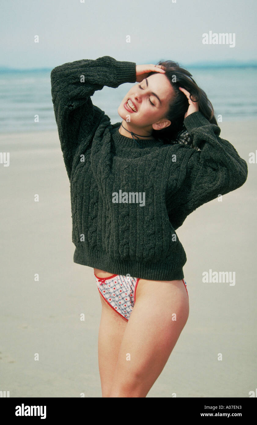Girl in a Green Jumper on a Beach Stock Photo