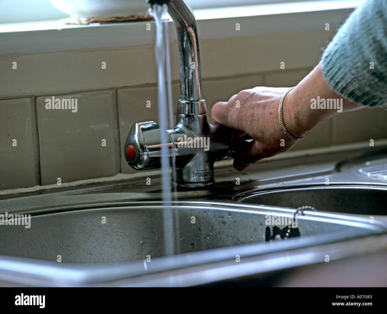 STILL LIFE STUDIO Mature woman's hand turning on a kitchen mixer tap Stock Photo Alamy