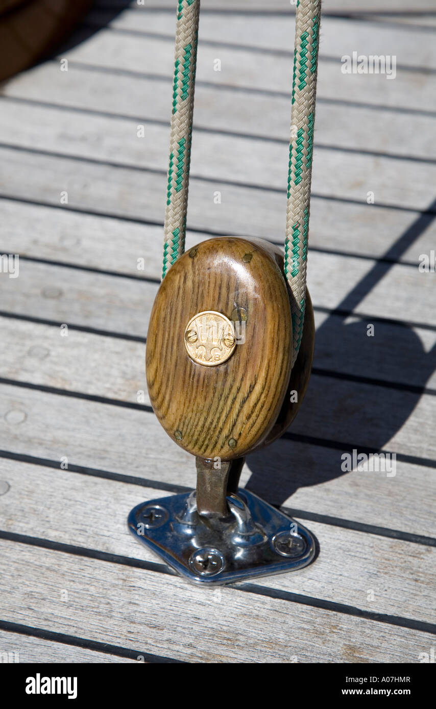 Polished wooden pulley on deck of boat USA Stock Photo