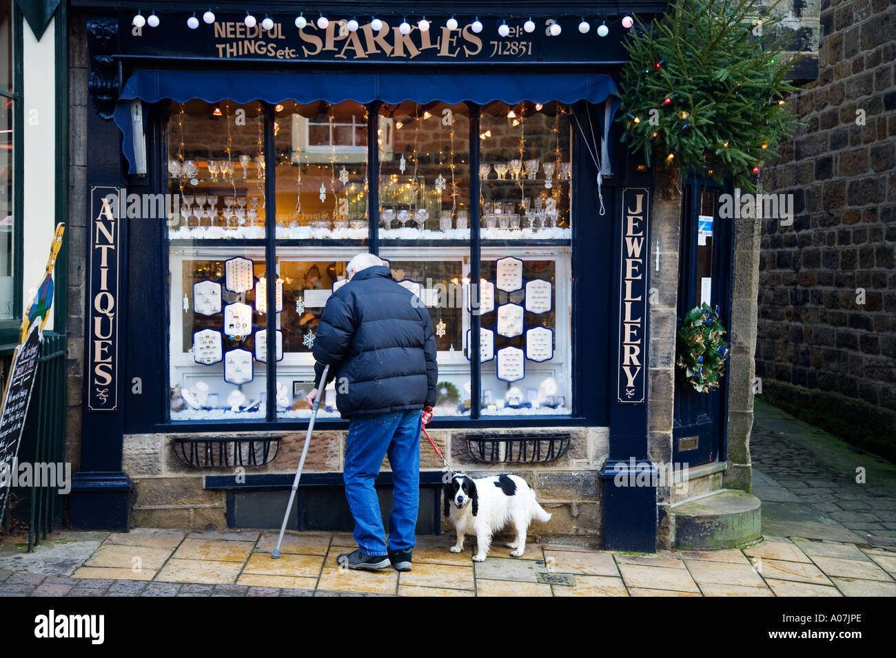 Man with Dog looking in Jeweller Shop Window in Pateley Bridge Nidderdale North Yorkshire England Stock Photo