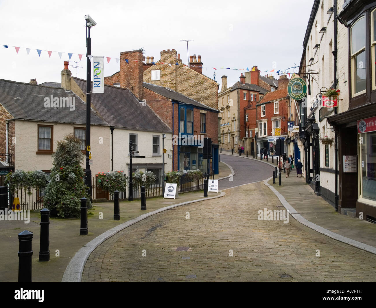 Kirkgate a cobbled street with traditional small shops in Ripon North