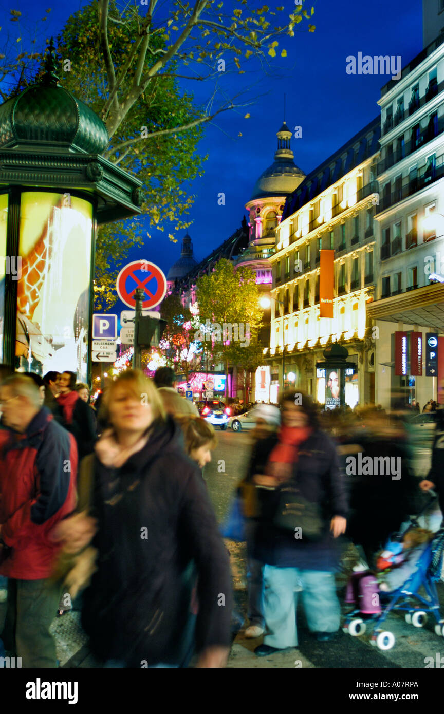 Paris France, Busy Street Scene Shopping Area Near 'Le Printemps Department Store' 'Boulevard Haussmann' Blurred Crowd Moving at Night Stock Photo
