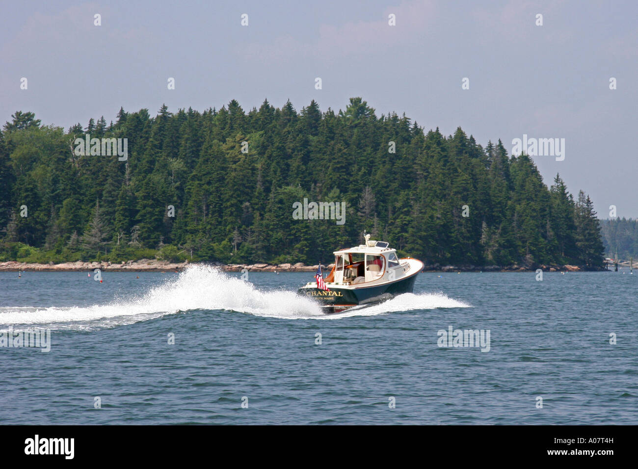 The small motoryacht CHANTAL underway at Ebenecook Harbor, Southport Island, Maine Stock Photo