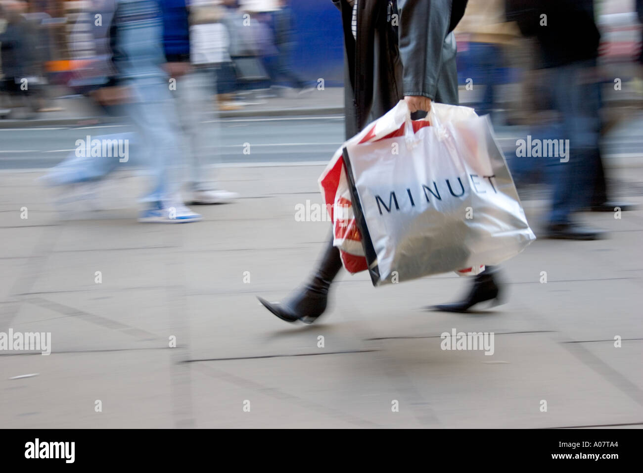 Shoppers in  January sales in Oxford Street London with minuet plastic bag Stock Photo
