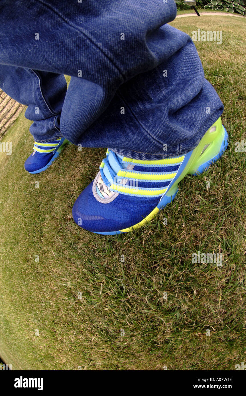 training shoes jeans wideangle fisheye lens lawn grass green movement