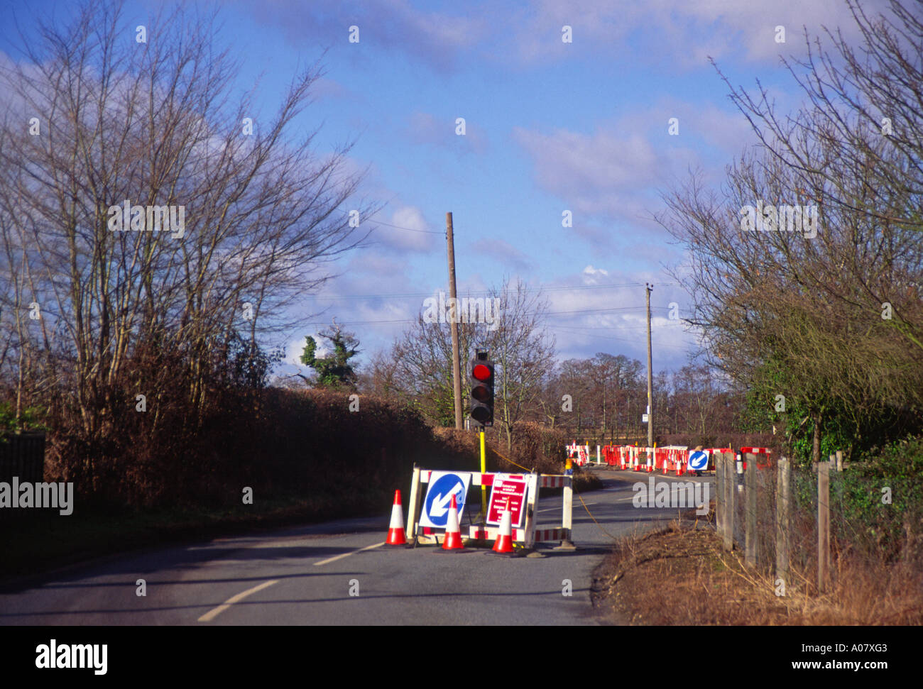 Red traffic light at roadworks on country road Stock Photo Alamy