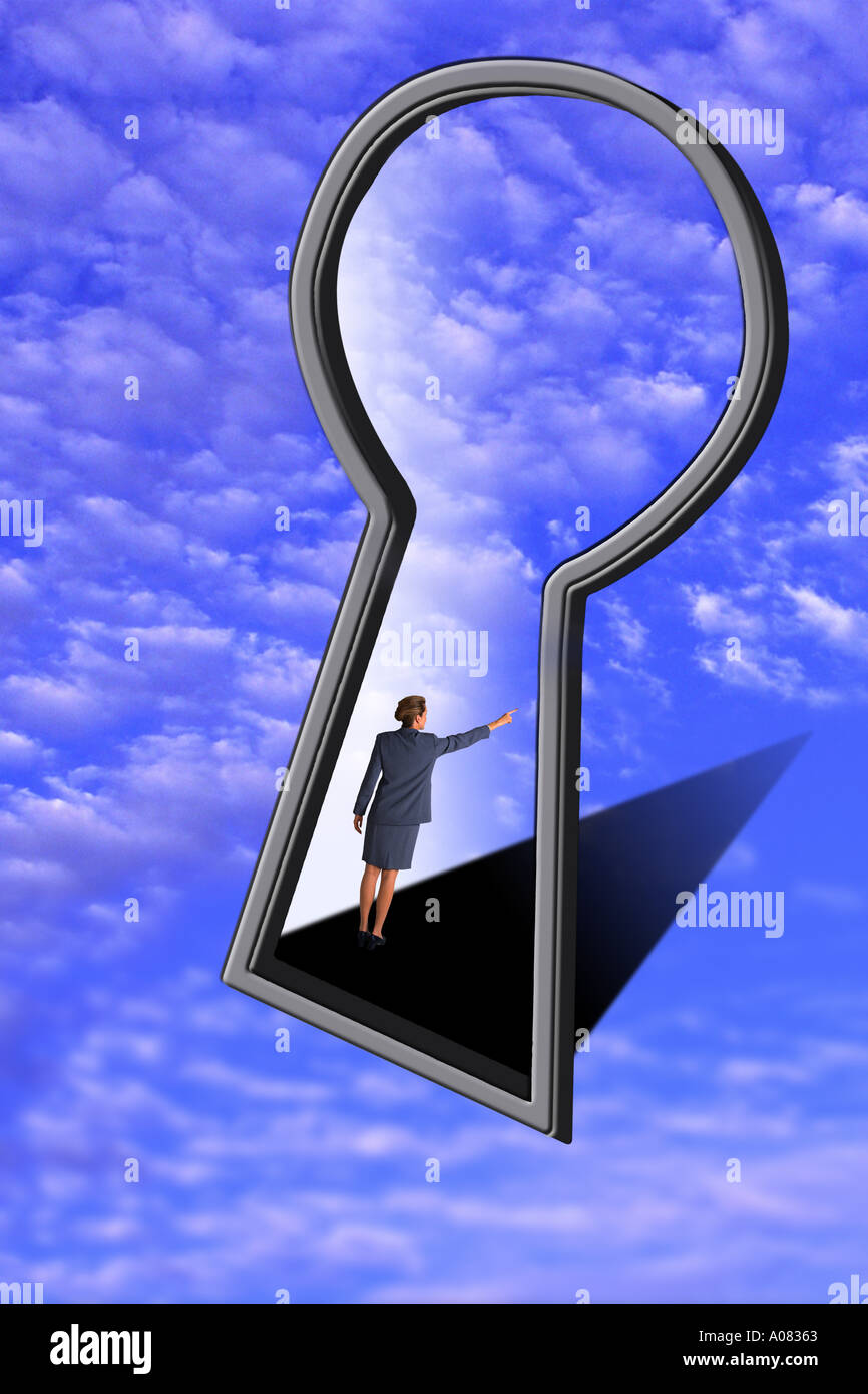 Businesswoman looking through keyhole Stock Photo